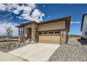 Beautifully landscaped single-Gathering home showcasing stone accents and a two-car garage at 400 Basin Daisy St, Castle Rock, CO 80104