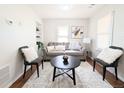 Bright living room featuring a comfortable gray sofa, stylish furniture, and warm natural light at 2092 Elmira St, Aurora, CO 80010