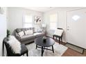 Bright living room with a plush gray sofa, modern decor, and plenty of natural light at 2092 Elmira St, Aurora, CO 80010