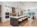 Modern kitchen features a large center island, stainless steel appliances, and sleek finishes at 10252 E 58Th Ave, Denver, CO 80238