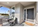 Inviting front porch with seating for two, creating a welcoming entryway at 944 Black Saddle St, Elizabeth, CO 80107