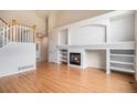 Bright living room with hardwood floors, fireplace, and built-in shelving offering a cozy and inviting atmosphere at 11862 W Stanford Pl, Morrison, CO 80465