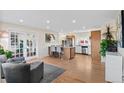 Bright, open-concept kitchen with an island, seating, and stainless steel appliances at 3256 S Glencoe St, Denver, CO 80222