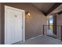 Apartment entrance featuring a white door with the number 72 and a modern lantern at 875 E 78Th Ave # 72, Denver, CO 80229