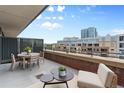 Inviting balcony offers a perfect spot for relaxation with stylish seating and scenic city views at 2100 16Th St # 600, Denver, CO 80202
