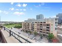 Balcony offers a view of a green space and city architecture at 2100 16Th St # 600, Denver, CO 80202