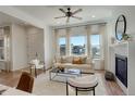 Bright and airy living room featuring a fireplace, large windows, and modern furnishings at 16550 Umatilla Pl, Broomfield, CO 80023