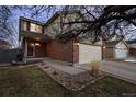 Charming two-story home with brick accents, attached garage, and front yard landscaping at 13096 Birch Dr, Thornton, CO 80241