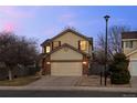 Well-maintained two-story home with attached garage, manicured lawn, and street view at 13096 Birch Dr, Thornton, CO 80241