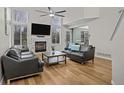 Bright and airy living room features a vaulted ceiling, fireplace, and gleaming hardwood floors at 13096 Birch Dr, Thornton, CO 80241