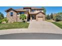 Two-story house with stone accents and a three-car garage at 13699 Pecos Loop, Broomfield, CO 80023