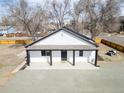 This stylish home showcases a clean white exterior, contrasted by black trim and a cozy covered entryway at 801 S Leyden St, Denver, CO 80224