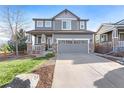 Two-story house with gray siding, stone accents, and a two-car garage at 3087 Black Canyon Way, Castle Rock, CO 80109