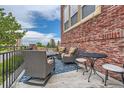 Inviting patio features comfortable seating, a small table, and a stylish blue patterned rug at 9424 Ridgeline Blvd # I, Highlands Ranch, CO 80129