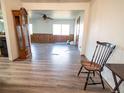 Open-concept living area with wood-look floors, paneling, a ceiling fan, and ample natural light at 1501 E Caley Ave, Centennial, CO 80121