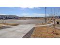 Wide view of the neighborhood cul-de-sac with well-maintained streets and sidewalks at 17761 E 95Th Pl, Commerce City, CO 80022