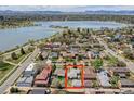 Aerial view showcases the property's location near a lake and mountains, highlighted with a red box around the property at 2028 Perry St, Denver, CO 80212