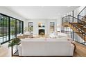 Bright living room featuring a fireplace, hardwood floors, and a staircase at 200 Magnolia St, Denver, CO 80220