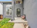 Inviting front porch with charming decor and a glimpse of the home's exterior at 8838 S Dudley St, Littleton, CO 80128