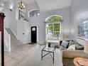 Bright living room with high ceilings, large windows, and neutral decor at 8838 S Dudley St, Littleton, CO 80128