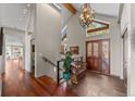 Grand entrance foyer with high ceilings, chandelier, tile flooring and wood accents throughout at 12653 Rancho Ct, Conifer, CO 80433