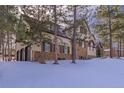 House exterior showcasing stone and stucco finishes, and a two-car garage at 590 Cumberland Rd, Larkspur, CO 80118