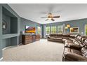 Cozy living room boasts plush carpeting, a ceiling fan, and multiple windows offering lots of natural light at 5238 Gould Cir, Castle Rock, CO 80109
