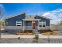 Beautiful home showcasing a blue exterior, stone accents, landscaped front yard, and a vibrant red front door at 5150 N Quemoy Ct, Aurora, CO 80019