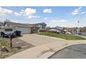 Wide driveway leads to this two-story home with attached garage and low maintenance lawn at 9683 Josephine Pl, Thornton, CO 80229
