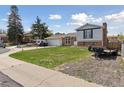 Charming split-level home with brick accents, a two-car garage, and well-maintained lawn at 9683 Josephine Pl, Thornton, CO 80229