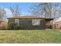 Attractive brick home featuring lush ivy covering the facade and a well-maintained lawn at 2784 W 4Th Ave, Denver, CO 80219
