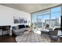 Contemporary living room with large windows offering city views, comfortable seating, and stylish decor at 891 14Th St # 3415, Denver, CO 80202