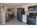 Modern kitchen with black appliances, adjacent to the dining room at 11894 Elk Head Range Rd, Littleton, CO 80127