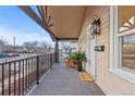 Inviting front porch featuring a cozy seating area, elegant lighting, and a welcoming entrance at 3912 S Acoma St, Englewood, CO 80110