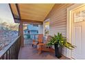 Charming front porch with wooden chairs, lovely greenery, and an inviting outdoor space at 3912 S Acoma St, Englewood, CO 80110