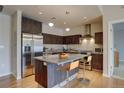 Modern kitchen featuring a stainless steel refrigerator, granite counters, and an island with seating at 410 Acoma St # 212, Denver, CO 80204