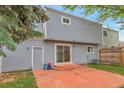 Back exterior of home featuring siding and a sliding glass door to patio at 19421 E Milan Cir, Aurora, CO 80013