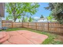 Fenced backyard featuring a concrete patio and grass yard at 19421 E Milan Cir, Aurora, CO 80013