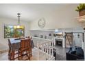 Open concept dining area with a view of the living room and fireplace at 644 Munson Ct, Berthoud, CO 80513