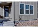 Charming front porch with steps leading to an inviting entrance and neat landscaping at 15869 E Otero Ave, Centennial, CO 80112