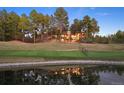 Scenic exterior of house overlooking golf course with reflection visible in the pond at 67 Indigo Way, Castle Rock, CO 80108