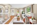 Bright living room with hardwood floors, neutral decor, and large windows offering ample natural light at 5740 S Cherokee St, Littleton, CO 80120