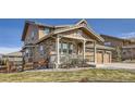 Beautiful exterior showcasing the home's architectural design, with a inviting covered porch and well-maintained landscaping at 15705 Red Deer Dr, Morrison, CO 80465