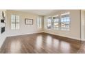 Bright living room with hardwood floors, plantation shutters, a modern fireplace, and large windows at 15705 Red Deer Dr, Morrison, CO 80465