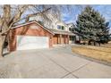 Two-story brick home with a white upper level and attached garage at 1861 Red Fox Pl, Highlands Ranch, CO 80126