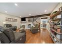 Spacious living room features hardwood floors, a fireplace, modern furniture, and open access to the kitchen at 6936 S Knolls Way, Centennial, CO 80122