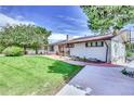 Side view of the house, highlighting the backyard and landscaping at 7475 W Kentucky Ave, Lakewood, CO 80226