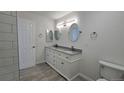 Bright bathroom features dual sinks, granite countertop, modern lighting, and a neutral color palette at 100 E Highline Cir # 307, Centennial, CO 80122