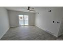 A bright living room with wood-look flooring, large window, and a ceiling fan at 100 E Highline Cir # 307, Centennial, CO 80122