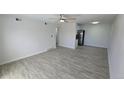 Spacious living room with light wood-look floors and a ceiling fan at 100 E Highline Cir # 307, Centennial, CO 80122
